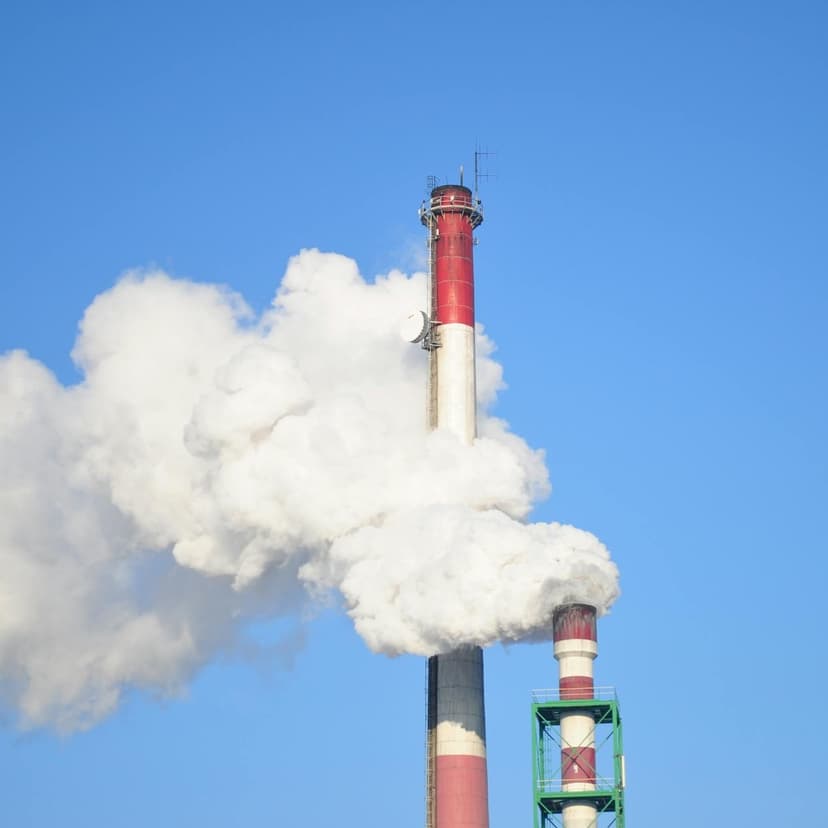 Smoke stacks against blue sky